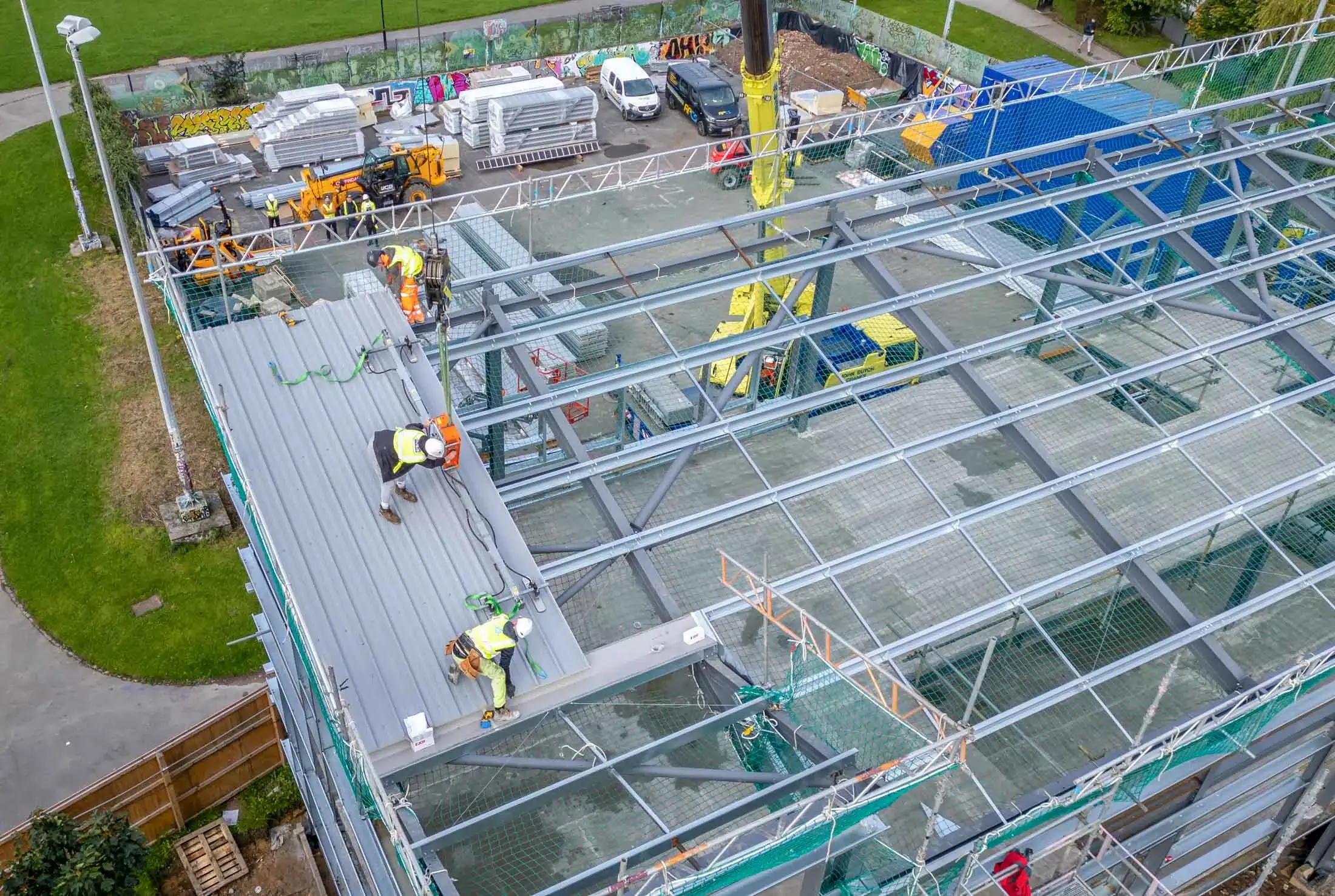 Aerial shot of workers undertaking steelwork on a new roof of a construction project