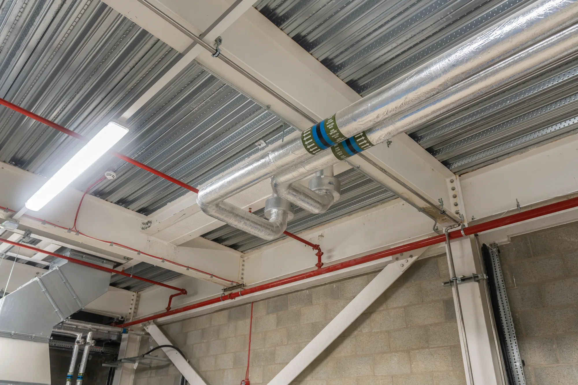 Jarvale-Construction-Decarbonisation-Services-4 Ceiling mounted pipework for building energy upgrade