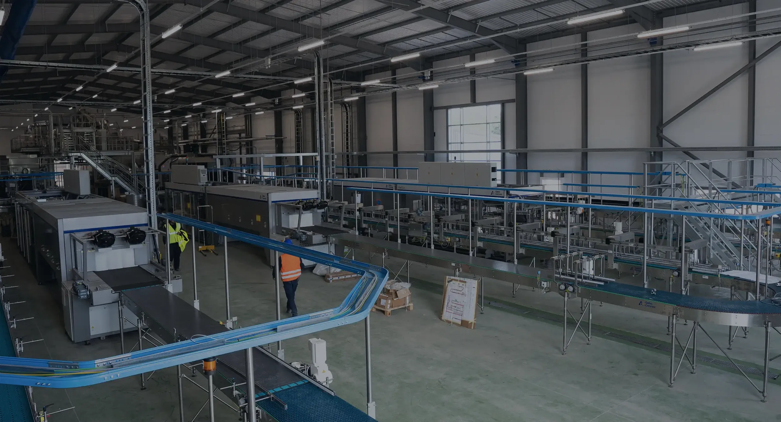 Interior of a modern industrial manufacturing facility with production lines and equipment